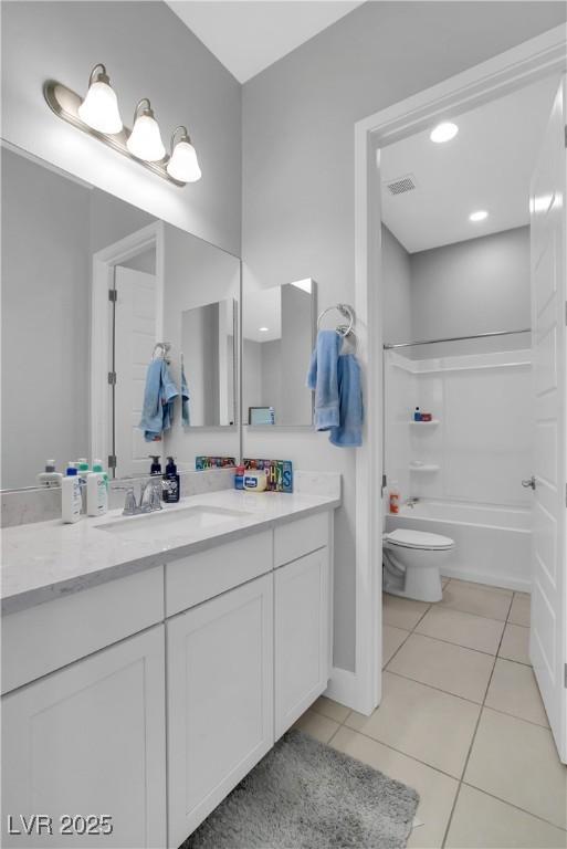 full bathroom featuring toilet, vanity, visible vents, tub / shower combination, and tile patterned floors