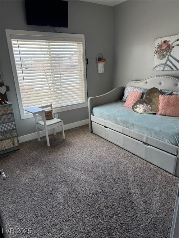 carpeted bedroom featuring baseboards