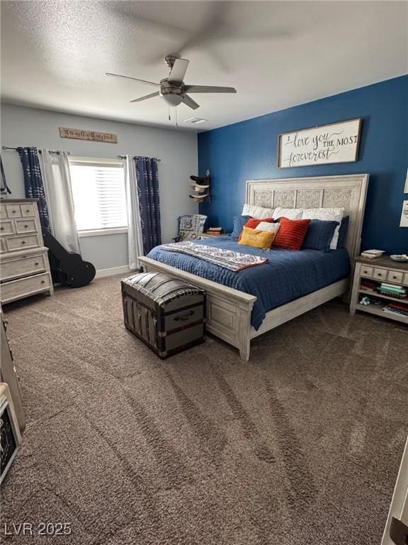 bedroom featuring a textured ceiling, carpet flooring, a ceiling fan, and baseboards