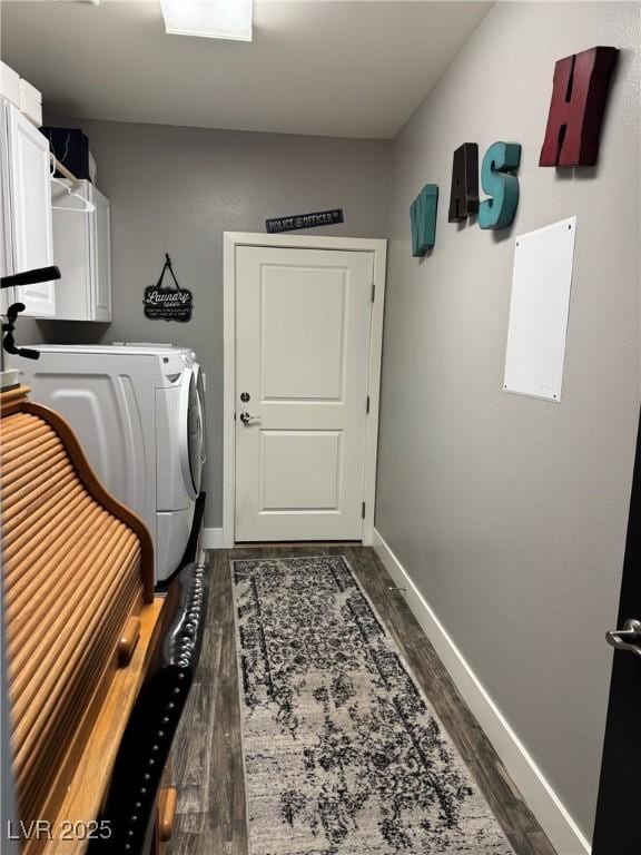 laundry area with dark wood-style floors, baseboards, cabinet space, and washer and dryer