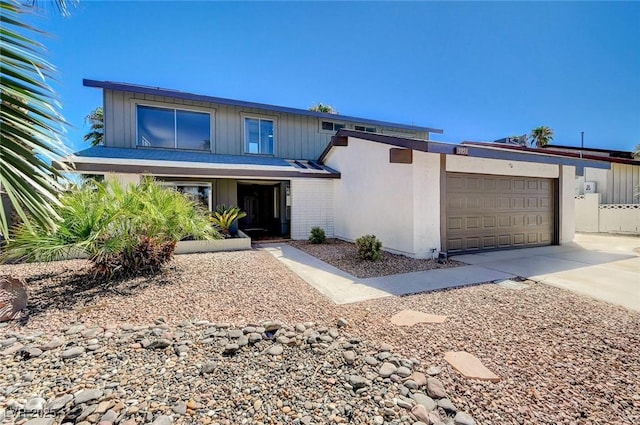 view of front of house with a garage and concrete driveway