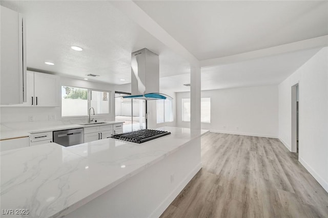 kitchen featuring stainless steel dishwasher, island exhaust hood, light stone counters, and a sink