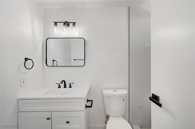 bathroom with toilet and vanity