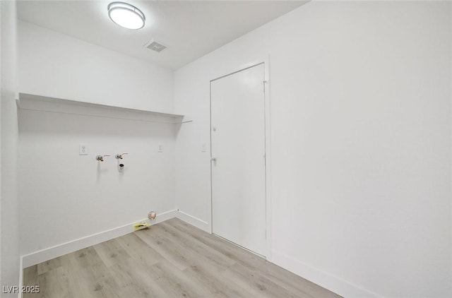 washroom with hookup for a gas dryer, laundry area, visible vents, baseboards, and light wood-type flooring