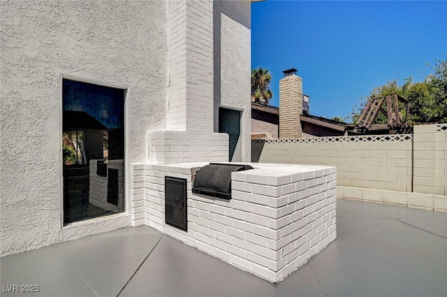 view of patio with fence and area for grilling