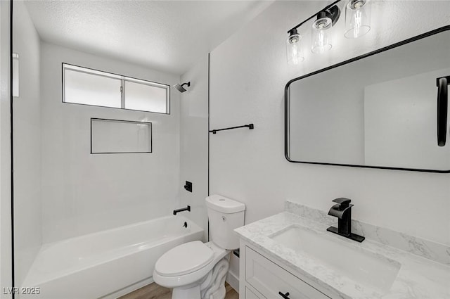 full bath with toilet, shower / bathing tub combination, a textured ceiling, and vanity