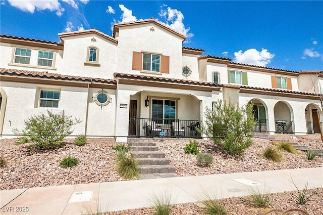 mediterranean / spanish-style house with a porch and stucco siding