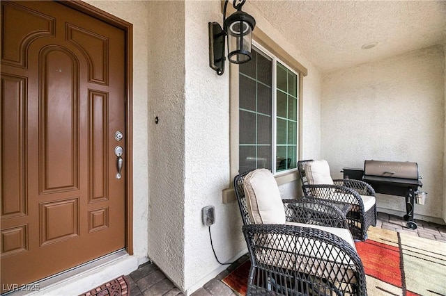 doorway to property featuring stucco siding