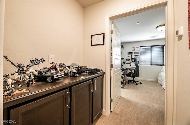 office area with light carpet and baseboards