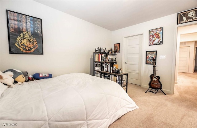 carpeted bedroom with visible vents and baseboards