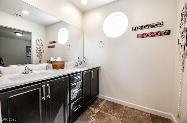 full bath featuring visible vents, a sink, baseboards, and double vanity