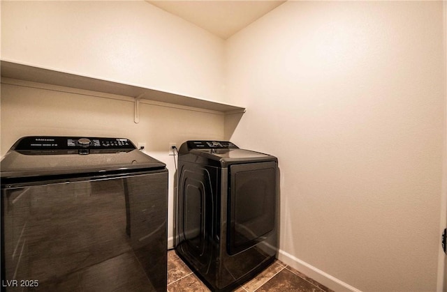 laundry room featuring laundry area, tile patterned floors, washing machine and dryer, and baseboards