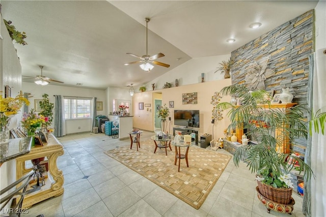 living room featuring a ceiling fan, tile patterned flooring, and vaulted ceiling