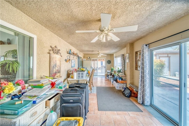 sunroom / solarium with a ceiling fan