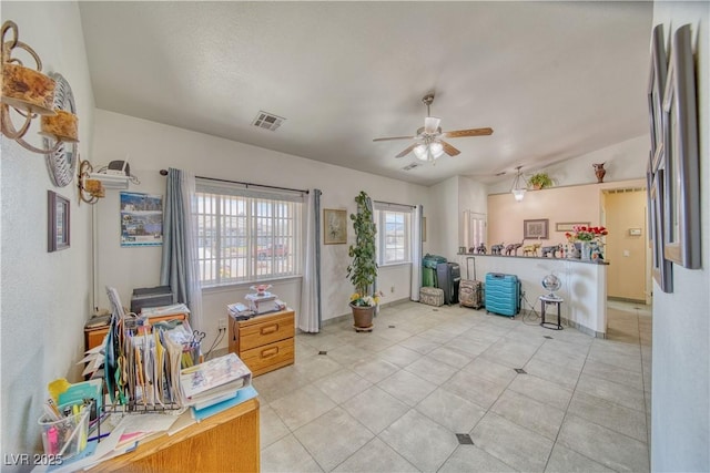 miscellaneous room featuring lofted ceiling, light tile patterned floors, a ceiling fan, and visible vents