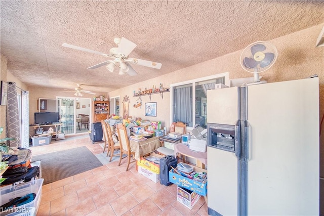 miscellaneous room featuring tile patterned floors, a textured ceiling, and a ceiling fan