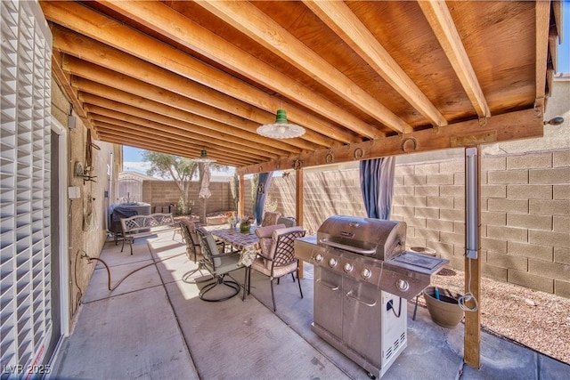 view of patio with outdoor dining space, a fenced backyard, and a grill