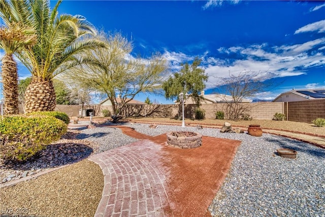 view of yard with a patio, a fire pit, and a fenced backyard