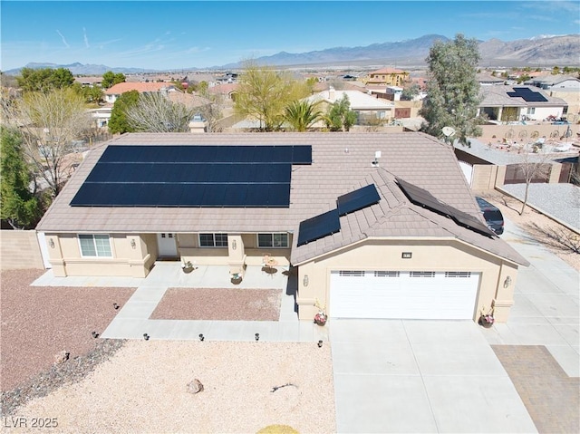 view of front of home with a mountain view, driveway, and stucco siding