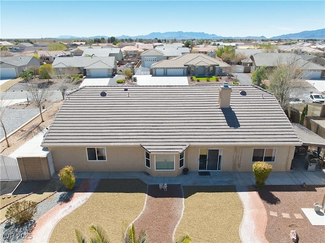 birds eye view of property featuring a mountain view and a residential view