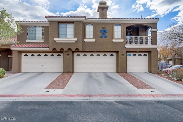 view of front of property featuring a garage, concrete driveway, and stucco siding