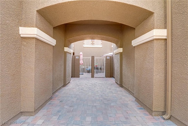 corridor featuring arched walkways