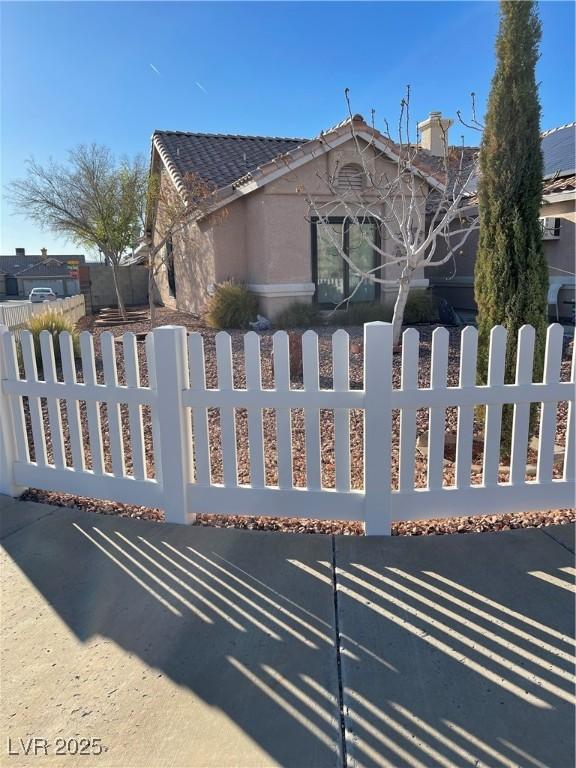 view of gate with a fenced front yard