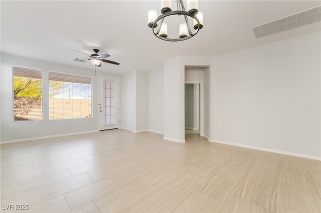 spare room featuring visible vents, baseboards, and ceiling fan with notable chandelier