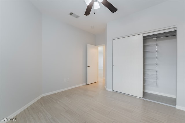 unfurnished bedroom featuring a ceiling fan, a closet, visible vents, and baseboards