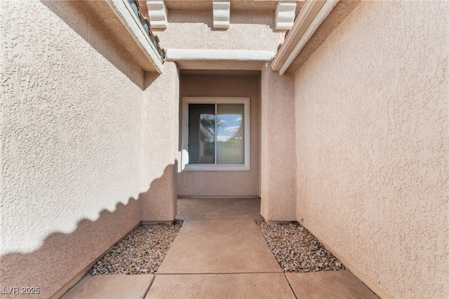 property entrance with stucco siding