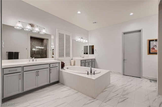 full bathroom featuring recessed lighting, a sink, marble finish floor, a shower stall, and a bath