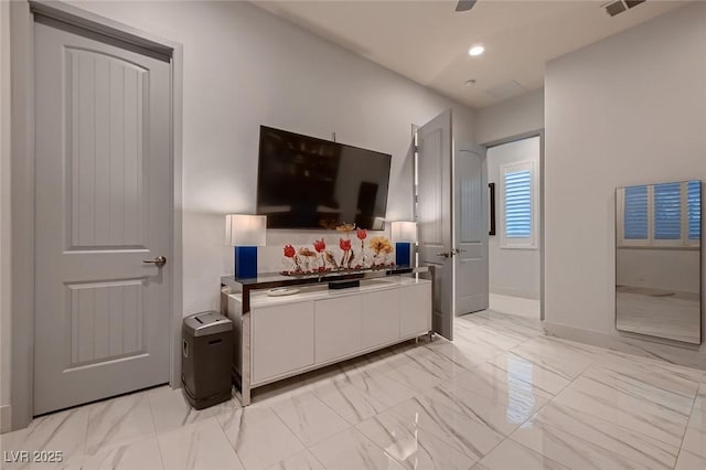 living room featuring marble finish floor, visible vents, baseboards, and recessed lighting