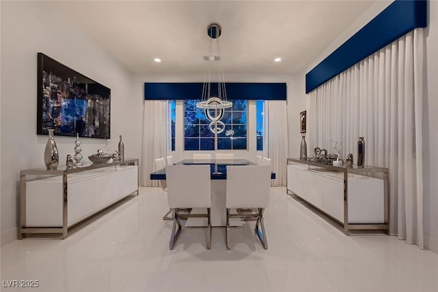 dining space with recessed lighting and an inviting chandelier