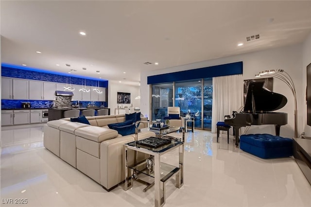 living area with visible vents and recessed lighting