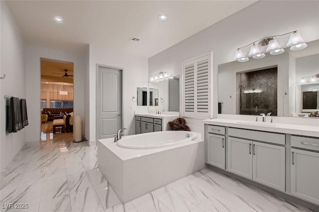 bathroom featuring a garden tub, recessed lighting, a sink, marble finish floor, and a tile shower