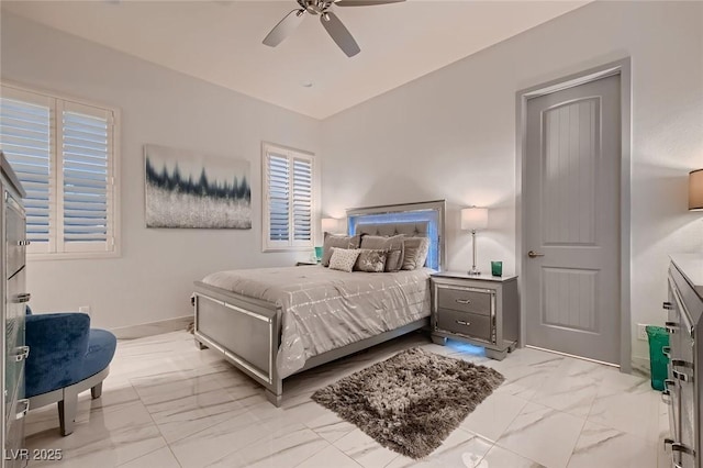 bedroom featuring marble finish floor, ceiling fan, and baseboards