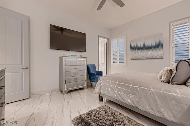 bedroom with a ceiling fan and marble finish floor