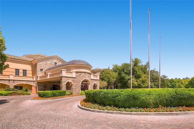 view of property with decorative driveway