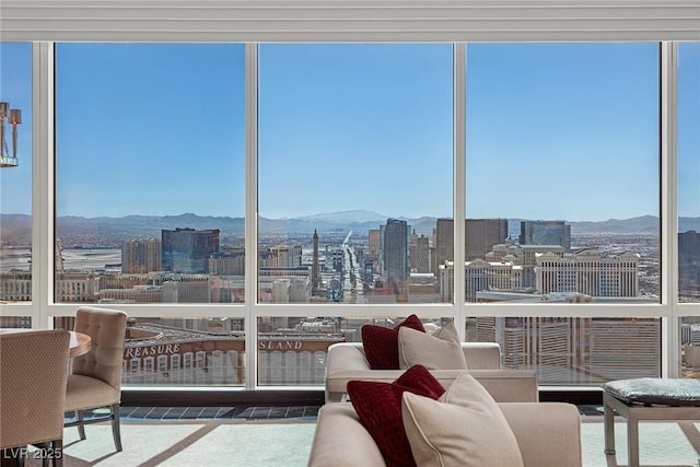 sunroom / solarium featuring a city view and a mountain view