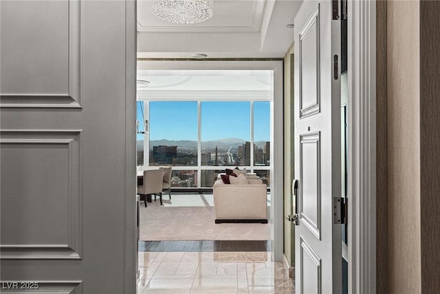 interior space with floor to ceiling windows, a mountain view, and ornamental molding