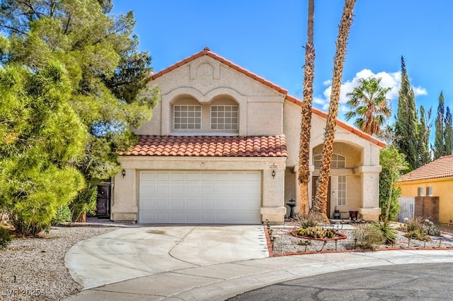 mediterranean / spanish house with a tiled roof and stucco siding