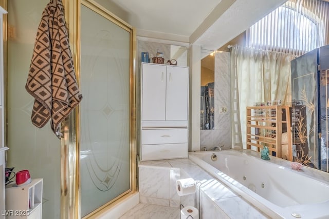 full bath featuring a stall shower, a tub with jets, and marble finish floor