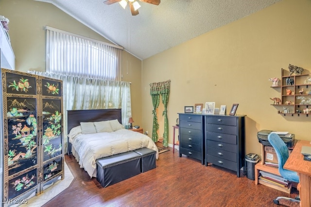 bedroom with a ceiling fan, lofted ceiling, a textured ceiling, and wood finished floors