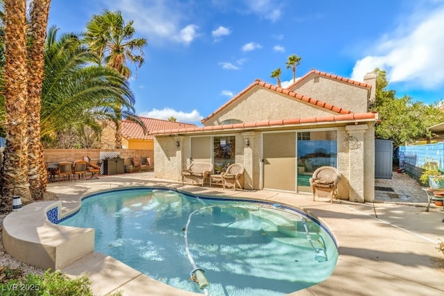 view of pool with a patio and fence