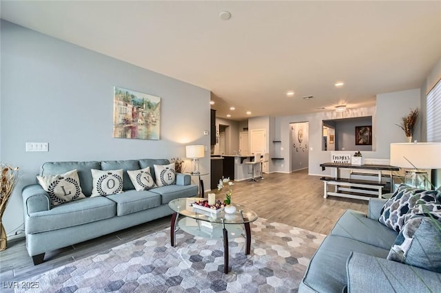 living area featuring recessed lighting and light wood-style floors