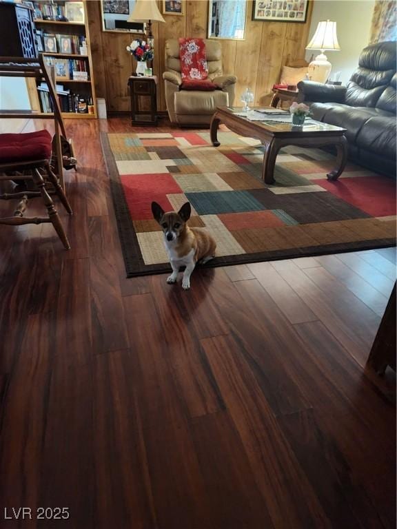 living area featuring wooden walls and wood finished floors