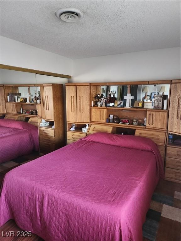 bedroom featuring visible vents and a textured ceiling