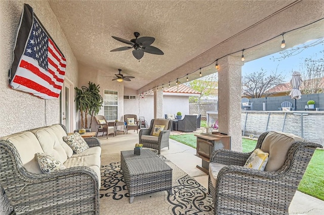 view of patio / terrace featuring ceiling fan, outdoor lounge area, and a fenced backyard