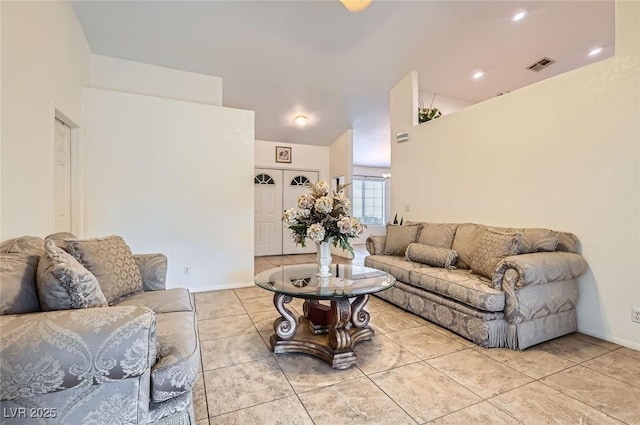 living room with baseboards, visible vents, and light tile patterned flooring