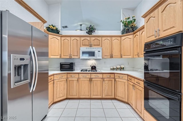 kitchen with white appliances, visible vents, light countertops, and light tile patterned flooring